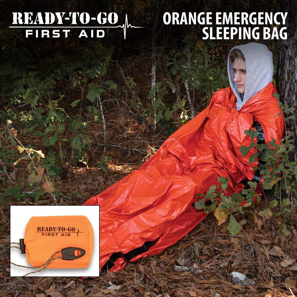 Full image of a person in the Ready-To-Go First Aid Orange Emergency Sleeping Bag. image number 0